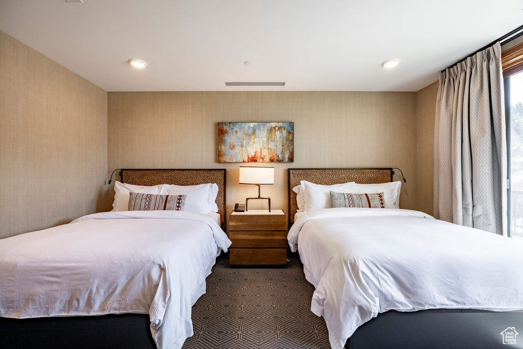 Carpeted bedroom with recessed lighting and wallpapered walls
