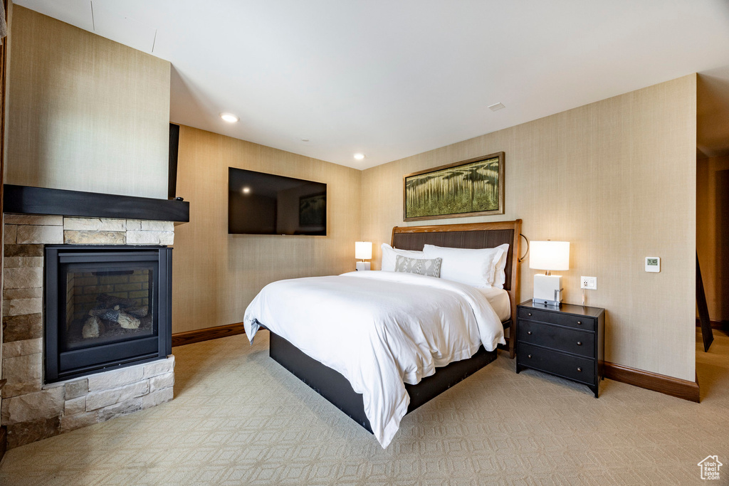 Bedroom featuring a fireplace, baseboards, carpet floors, and recessed lighting