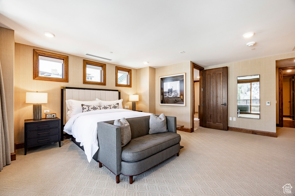Bedroom with baseboards and light colored carpet
