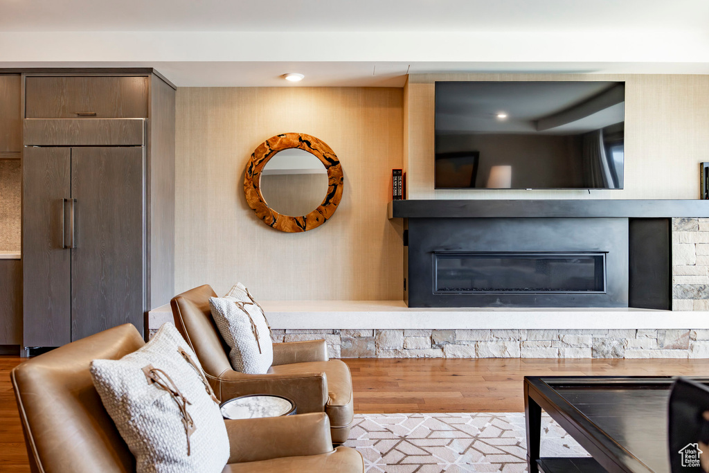 Living room featuring a fireplace, wood finished floors, and recessed lighting