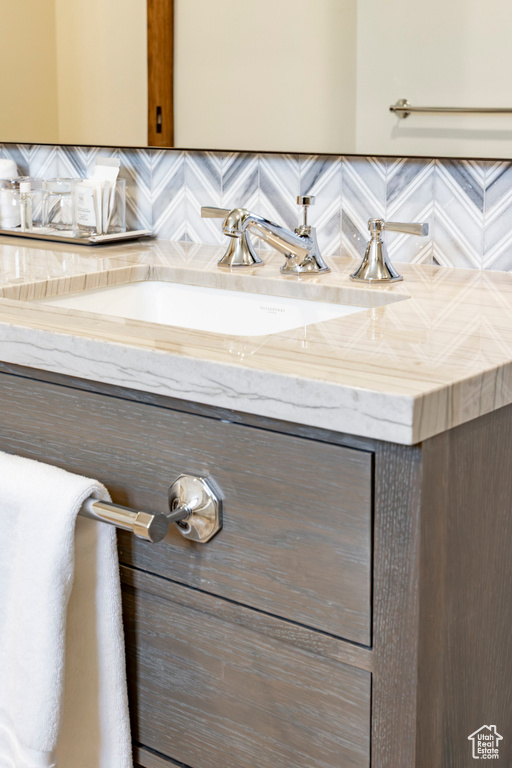 Bathroom featuring backsplash and vanity