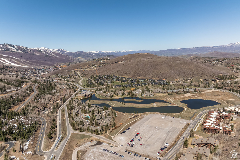 Drone / aerial view featuring a water and mountain view