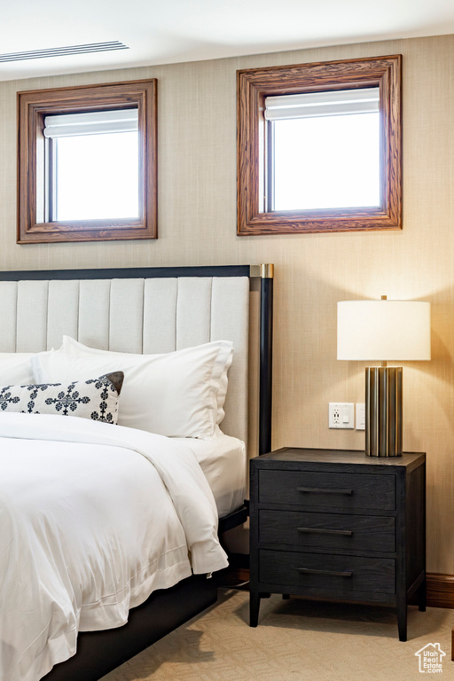 Bedroom with wallpapered walls