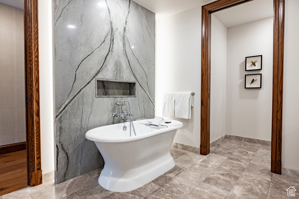 Bathroom with baseboards and a freestanding tub