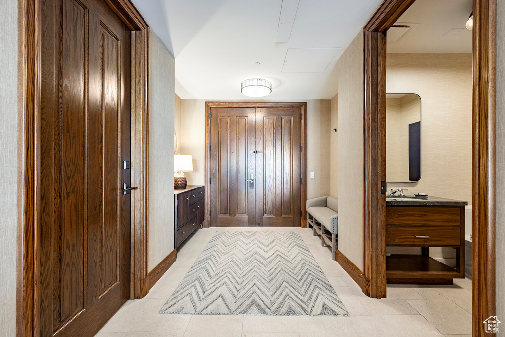 Interior space with baseboards and light tile patterned floors