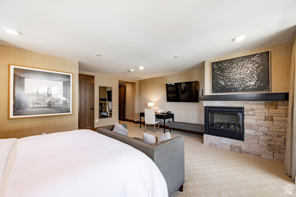 Bedroom featuring a fireplace, wallpapered walls, carpet floors, and recessed lighting