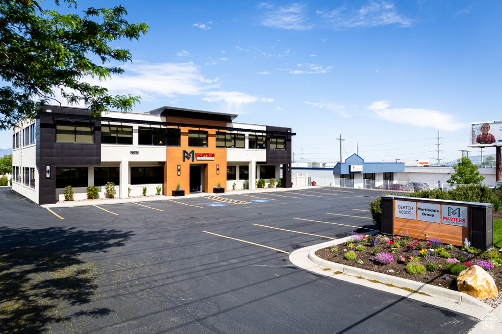 View of property featuring uncovered parking