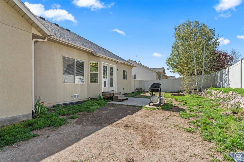 View of yard with a patio and a fenced backyard