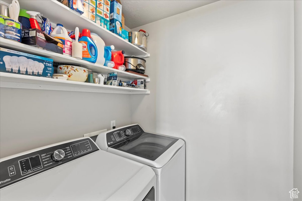 Washroom featuring washing machine and clothes dryer and laundry area