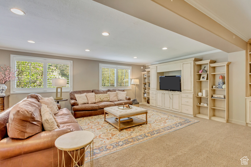 Living area featuring light carpet, recessed lighting, and ornamental molding