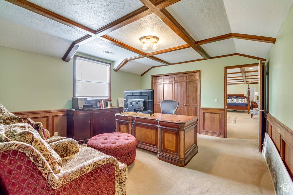 Office space featuring light carpet, a wainscoted wall, and a textured ceiling