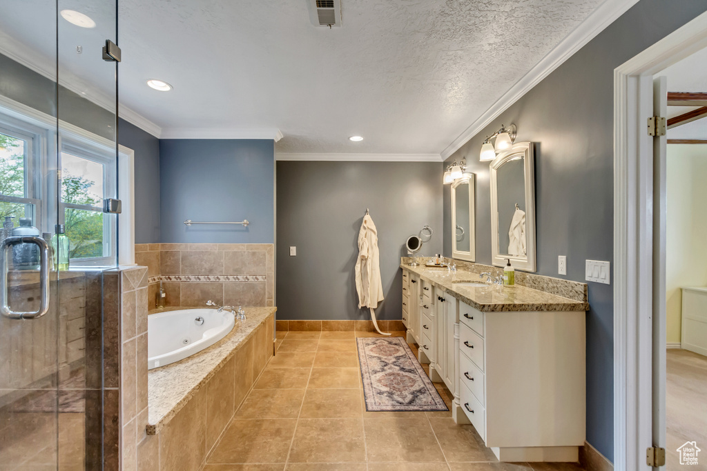 Full bathroom featuring a tub with jets, tile patterned floors, a stall shower, vanity, and baseboards
