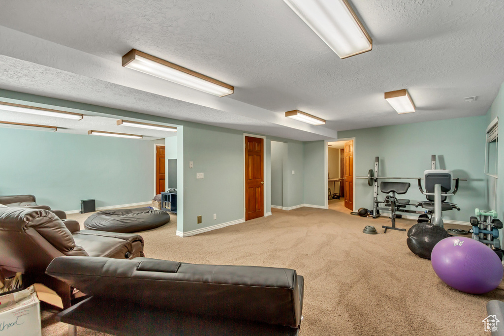 Interior space with a textured ceiling and baseboards