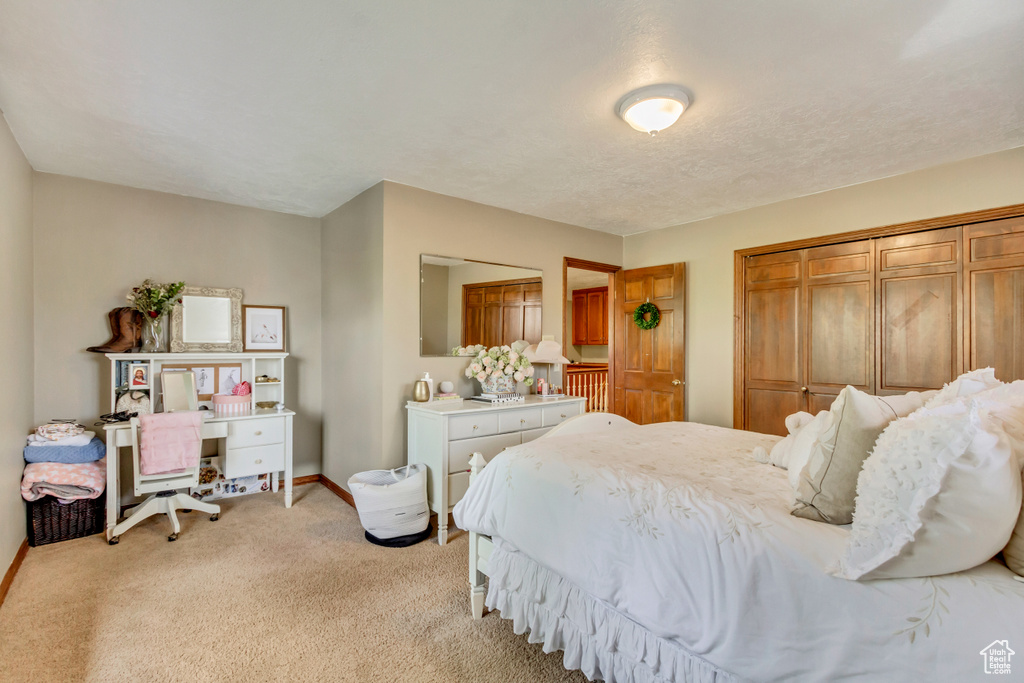 Bedroom featuring baseboards and light colored carpet