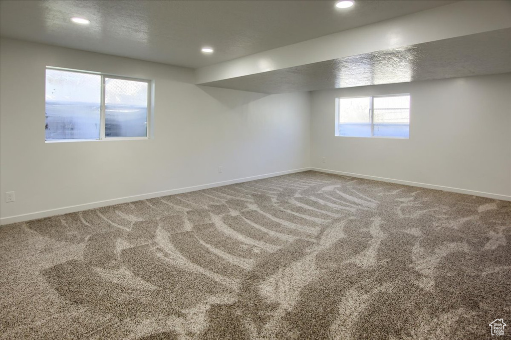 Below grade area featuring baseboards, carpet, and recessed lighting
