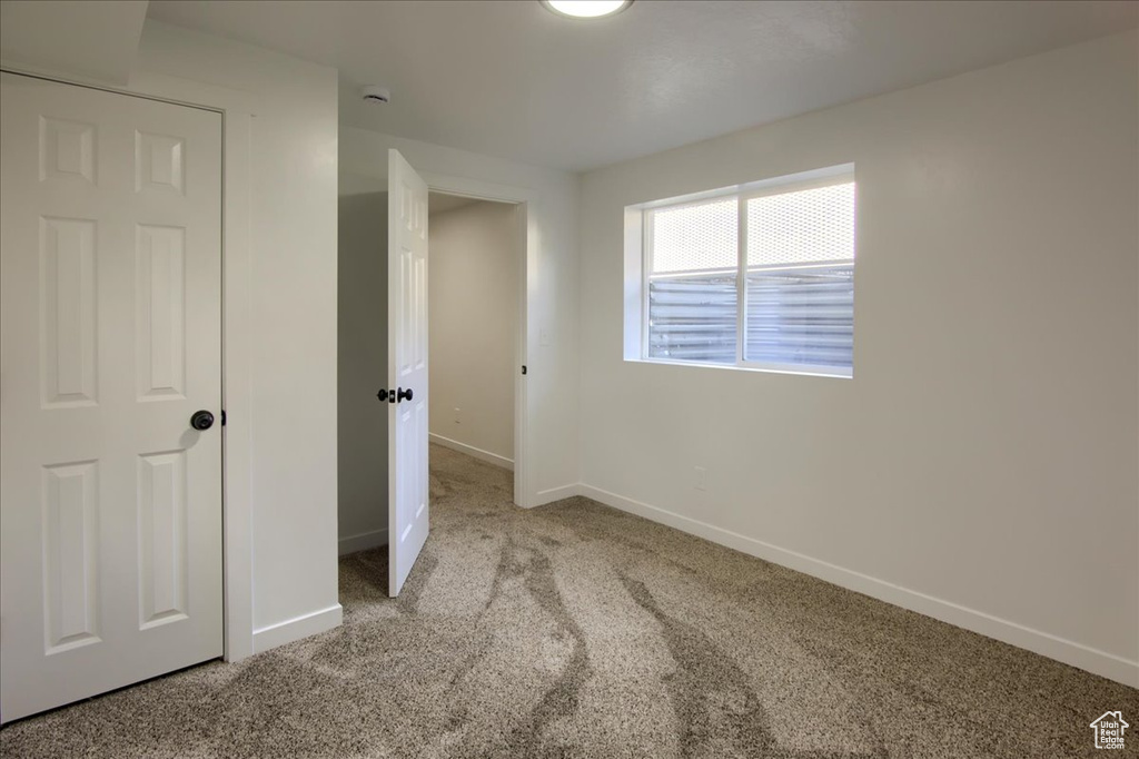 Unfurnished room with carpet floors and baseboards