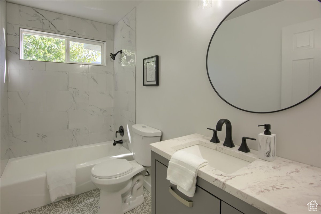 Full bathroom with toilet, shower / bathtub combination, and vanity
