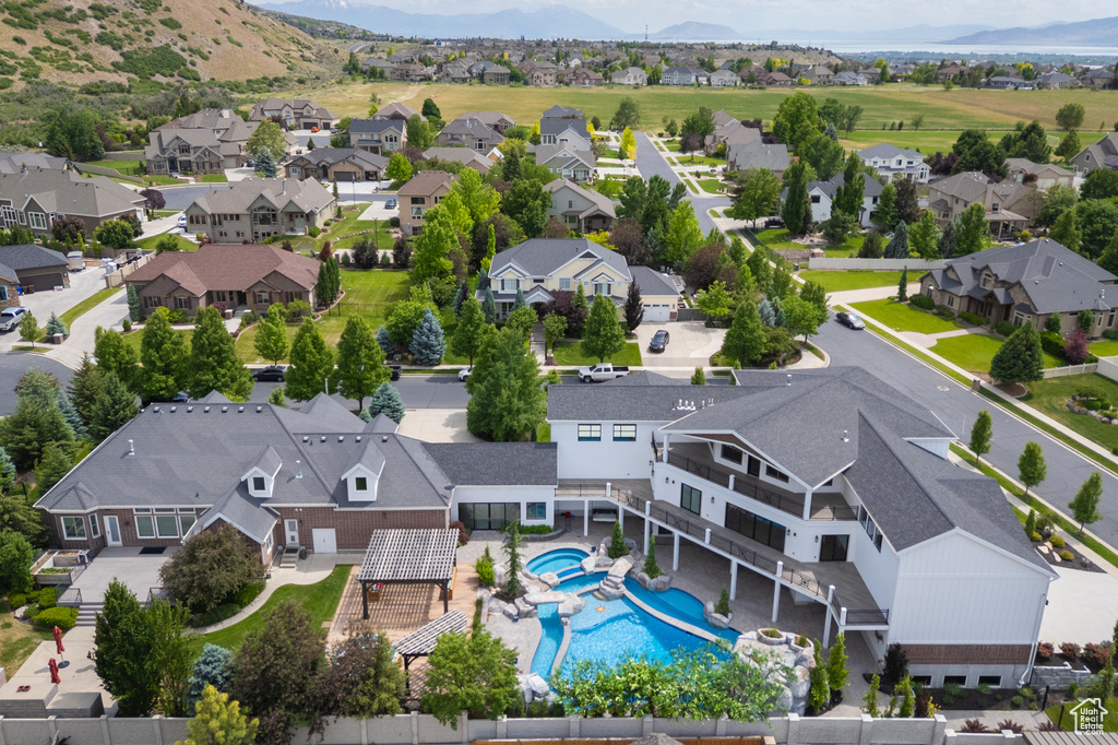 Aerial perspective of suburban area with a pool area and mountains