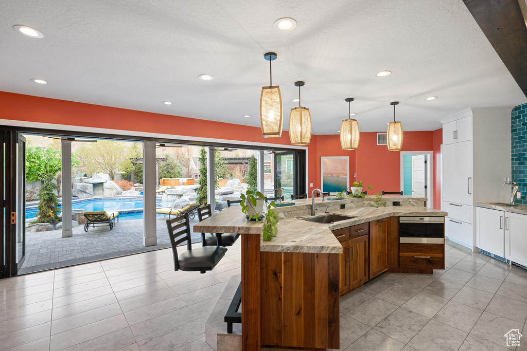 Kitchen with recessed lighting, a wealth of natural light, and a sink