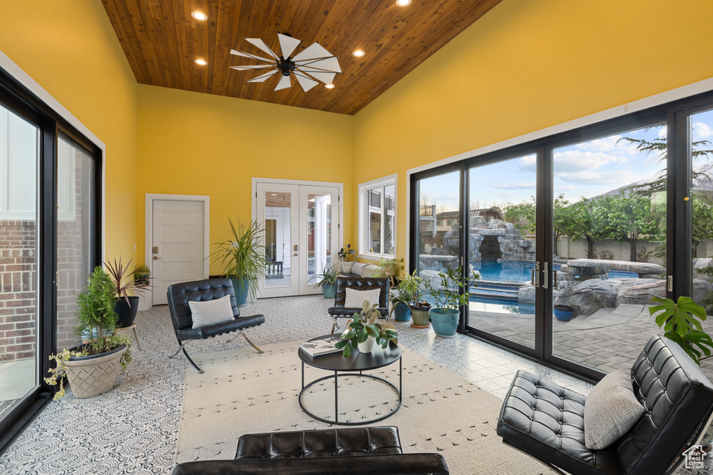 Sunroom / solarium featuring a wealth of natural light, a hot tub, and french doors