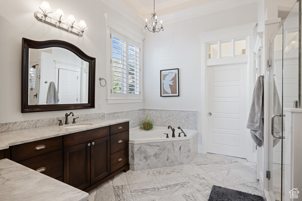 Bathroom with vanity, a bath, crown molding, a chandelier, and a stall shower