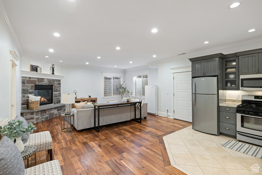 Kitchen featuring crown molding, wood finished floors, and appliances with stainless steel finishes