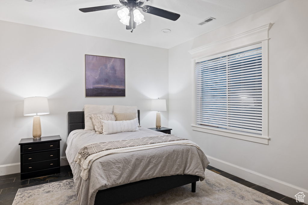 Bedroom featuring visible vents, a ceiling fan, and baseboards