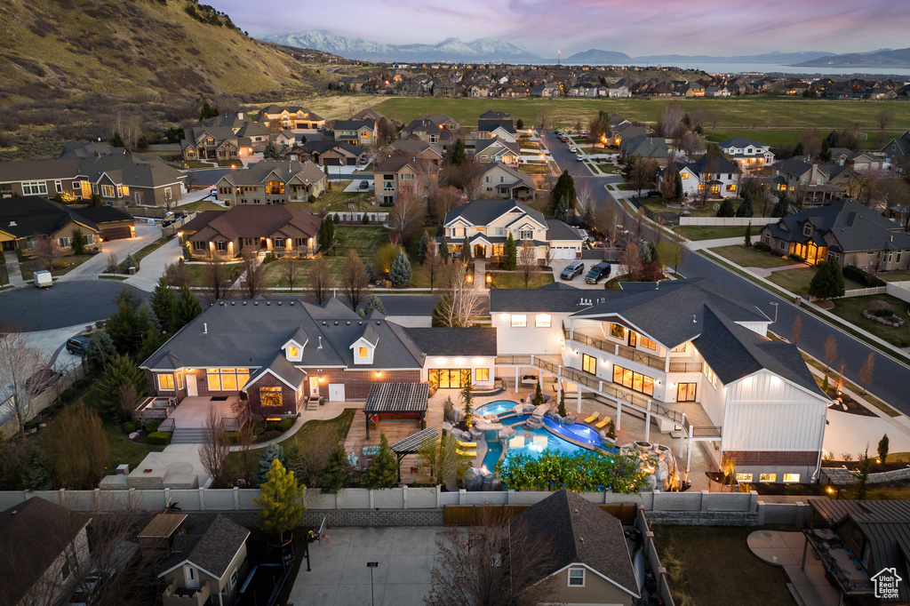 Aerial view at dusk featuring a residential view and a mountain view