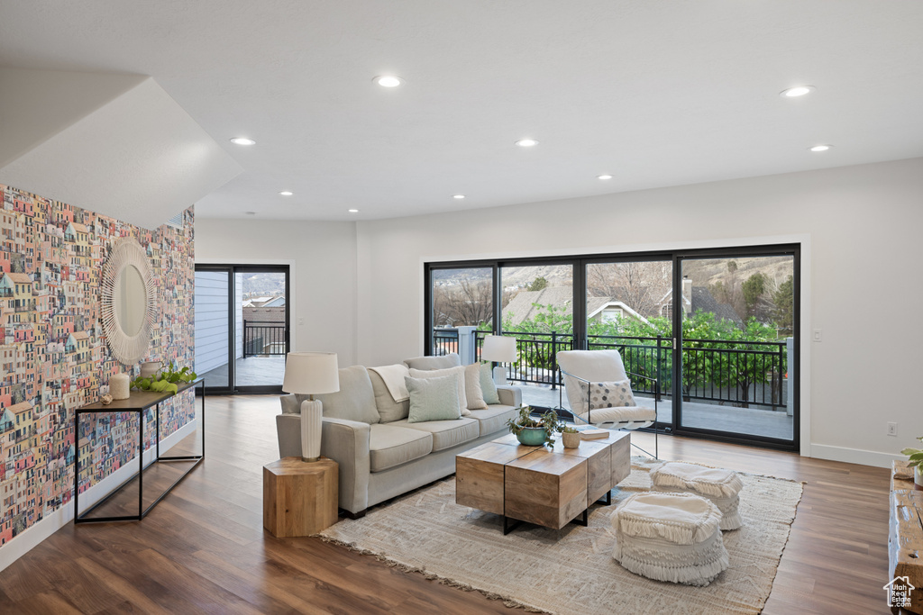 Living room with baseboards, wood finished floors, and recessed lighting