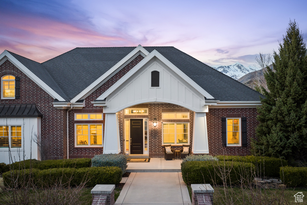 View of front facade featuring brick siding and board and batten siding