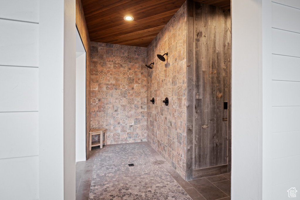 Full bath with recessed lighting, a tile shower, and wood ceiling