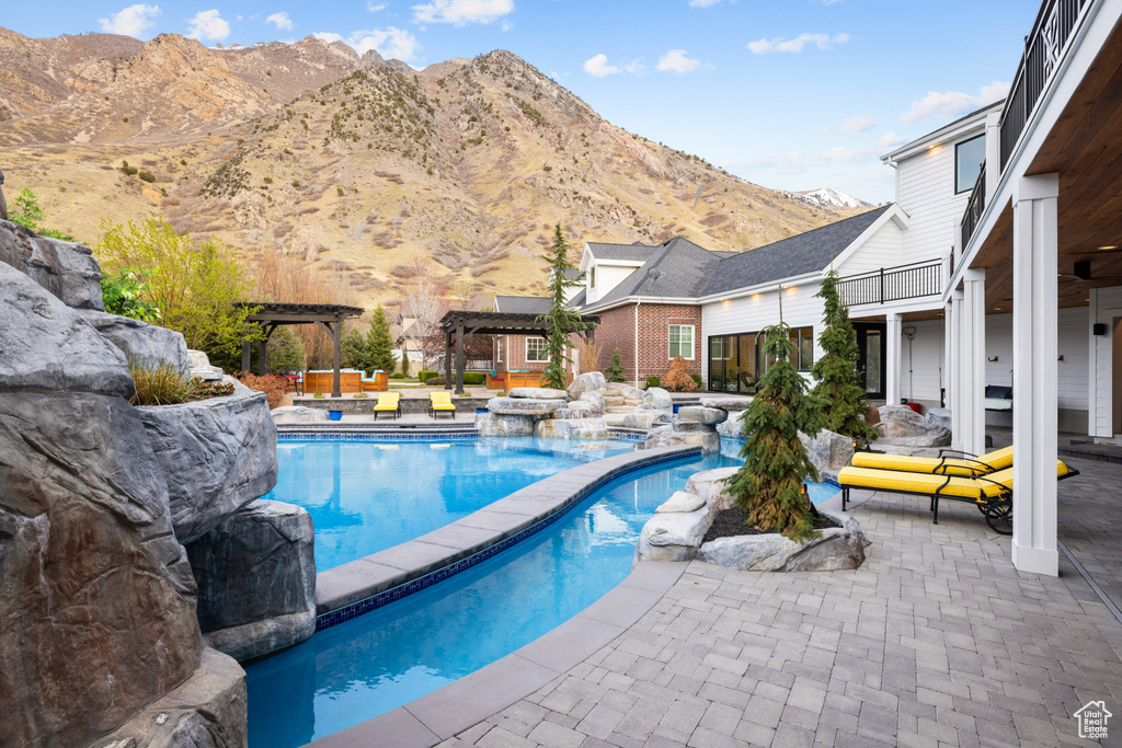 Pool featuring a pergola, a mountain view, and a patio