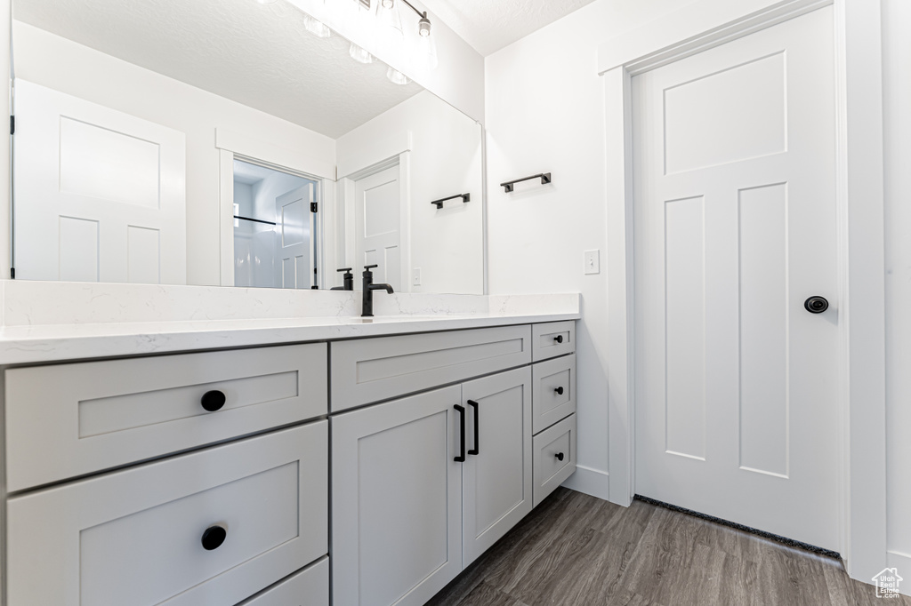 Bathroom featuring vanity and wood finished floors