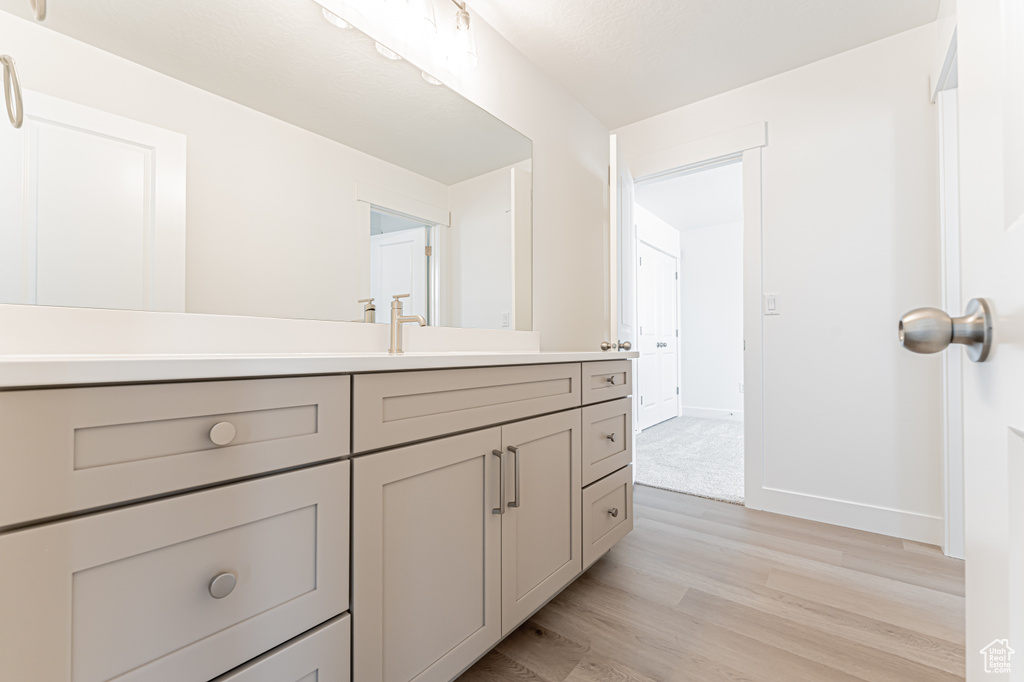 Bathroom featuring vanity and wood finished floors