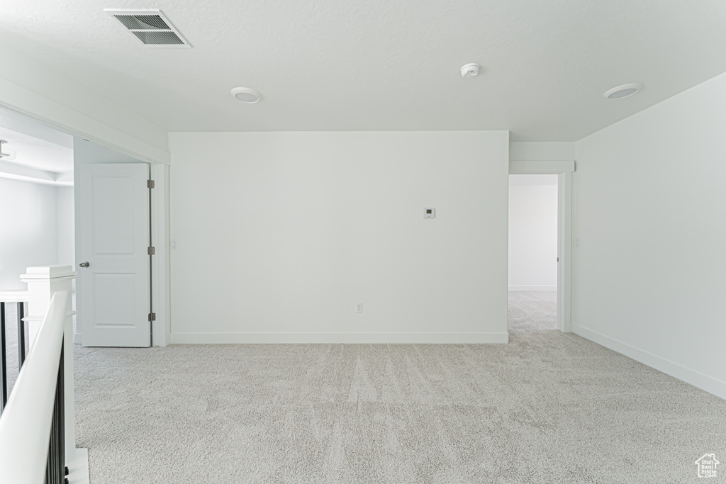 Spare room with carpet floors and a smoke detector