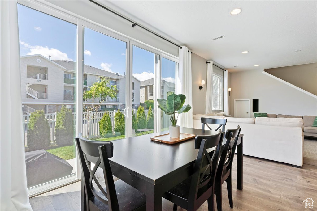 Dining space with light wood-type flooring, visible vents, and recessed lighting