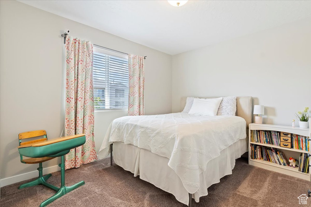 Bedroom with baseboards and carpet flooring
