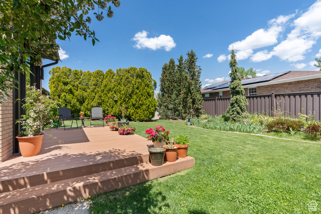View of yard featuring fence and a wooden deck