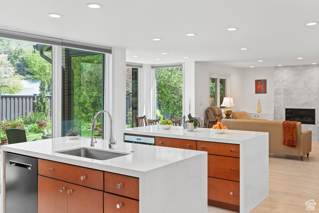 Kitchen featuring a sink, a kitchen island with sink, recessed lighting, and a healthy amount of sunlight