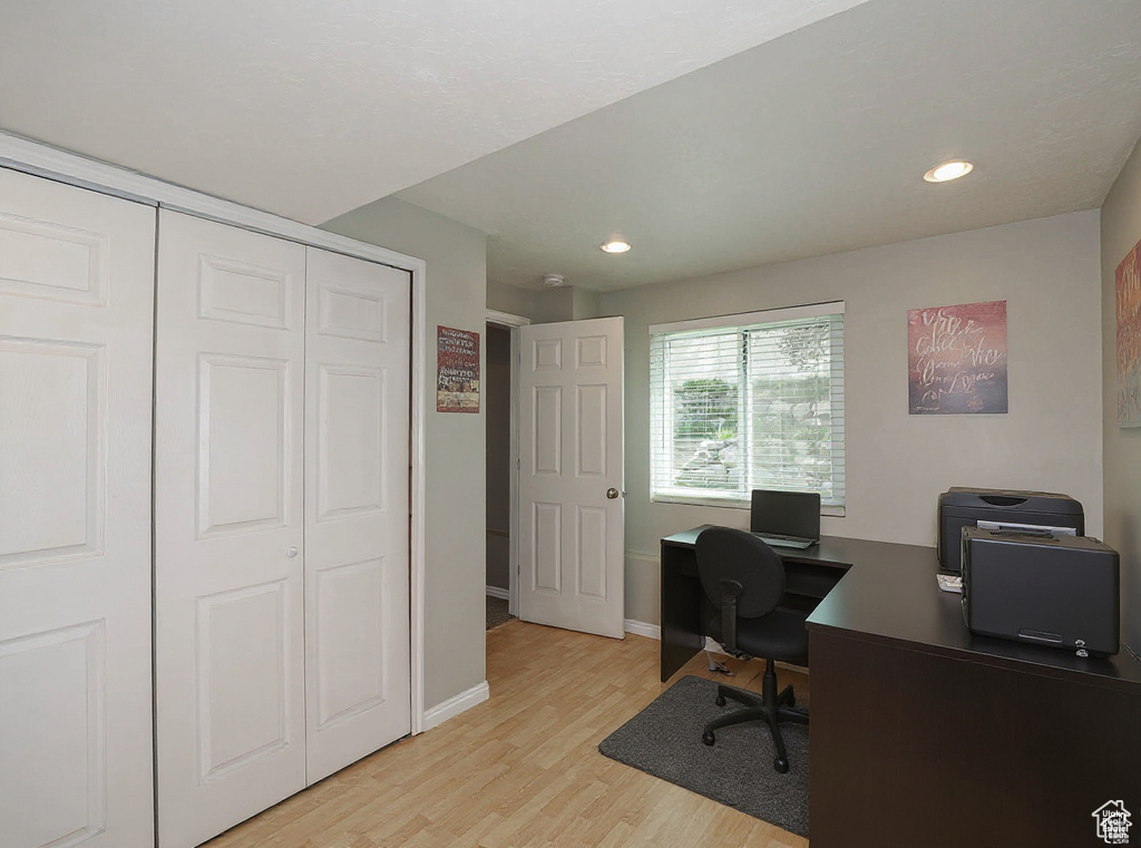 Office area featuring light wood-style flooring and recessed lighting