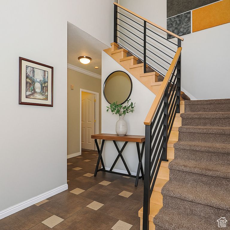 Stairs featuring ornamental molding and baseboards