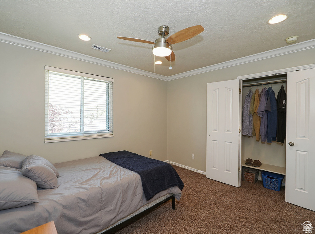 Carpeted bedroom with recessed lighting, a closet, ornamental molding, and ceiling fan