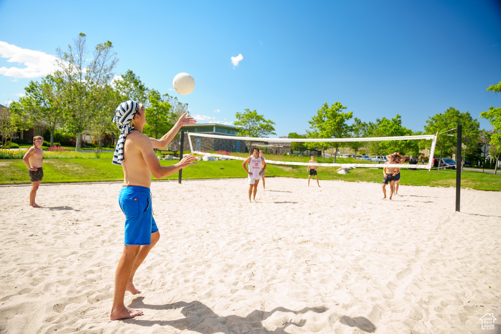 Surrounding community featuring volleyball court and a yard