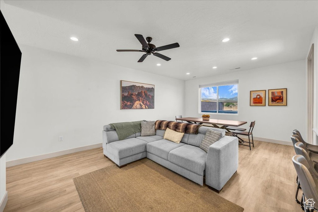 Living area with recessed lighting, ceiling fan, baseboards, and light wood-style floors