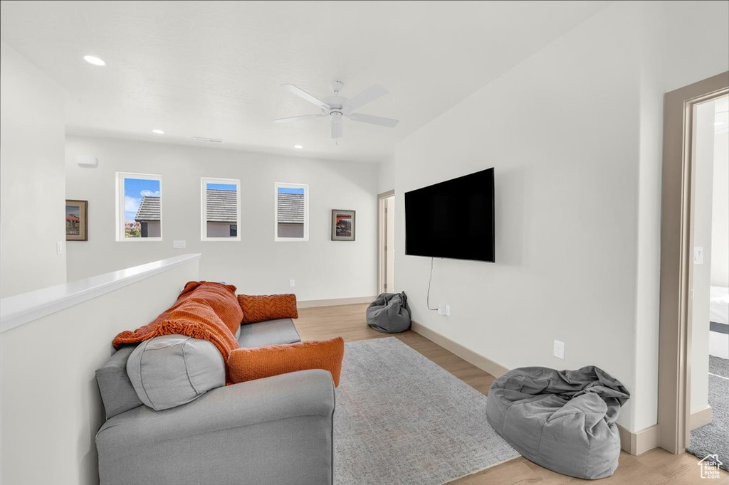 Living area with recessed lighting, a ceiling fan, baseboards, and light wood-style floors