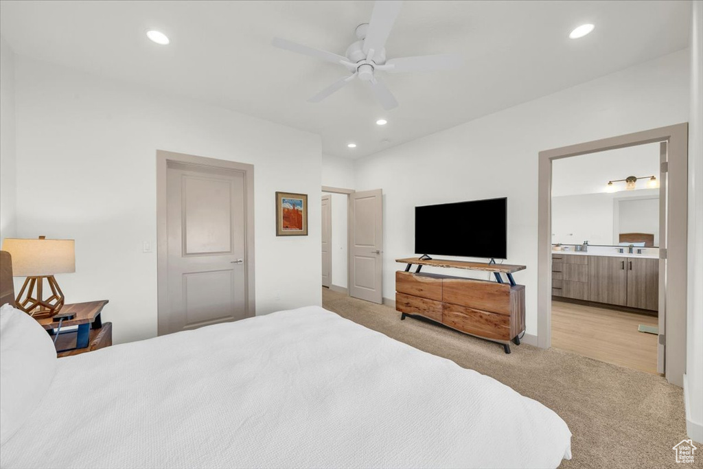 Bedroom with connected bathroom, recessed lighting, ceiling fan, and light colored carpet
