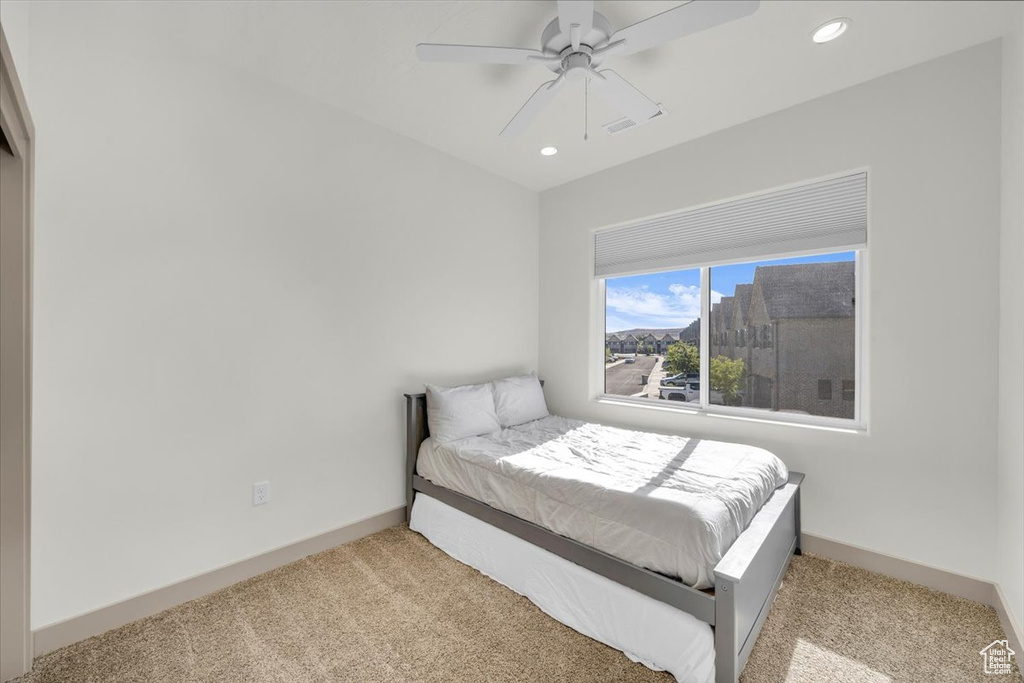 Carpeted bedroom featuring recessed lighting, a ceiling fan, and baseboards