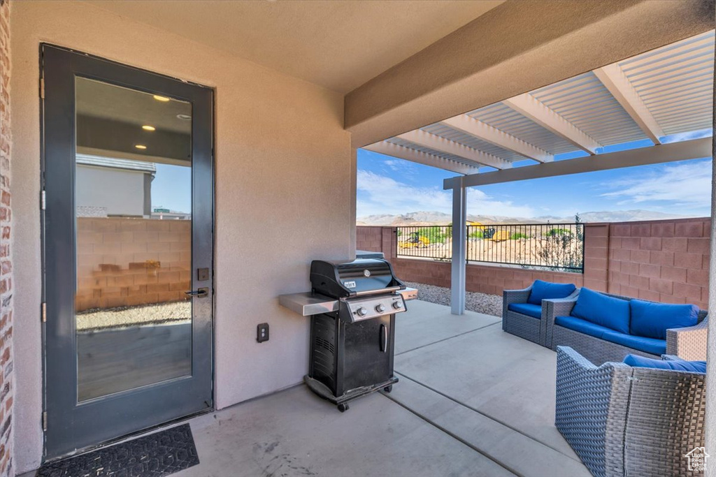 View of patio with fence, a pergola, an outdoor hangout area, and a grill