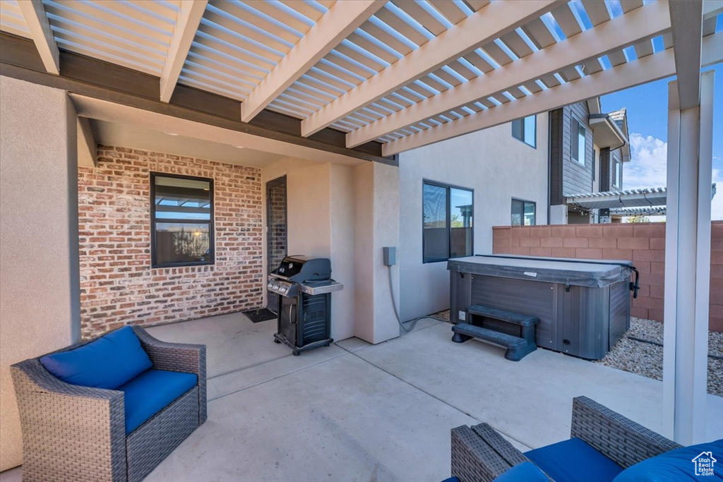 View of patio / terrace featuring a pergola, fence, area for grilling, and a hot tub