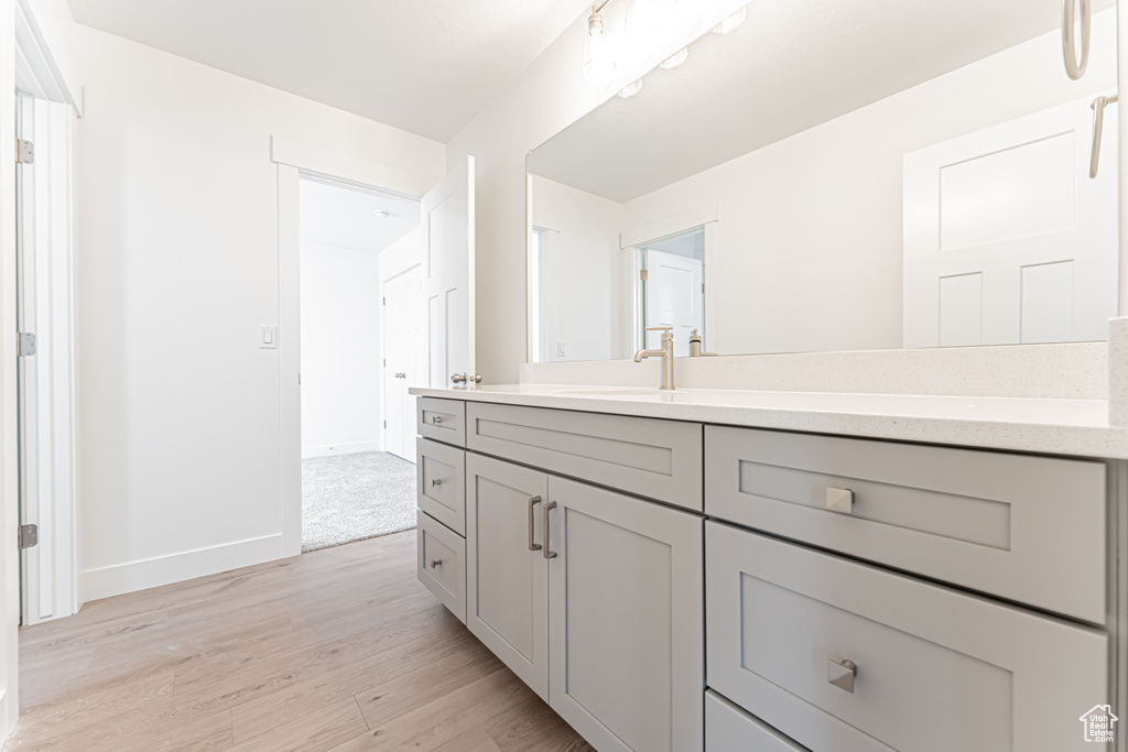 Bathroom with vanity and wood finished floors
